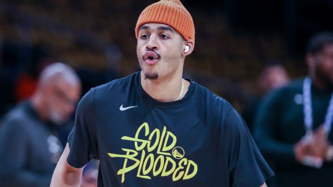 Jordan Poole warms up before a playoff game.