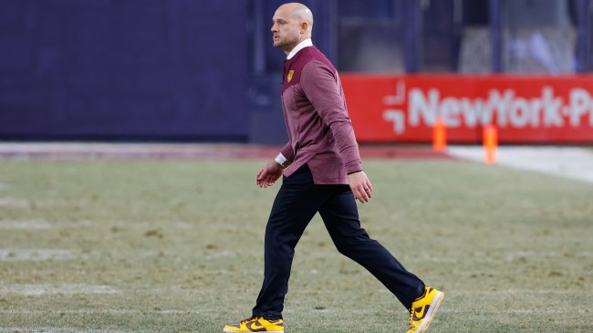 PJ Fleck walks onto the field during a Minnesota football game.