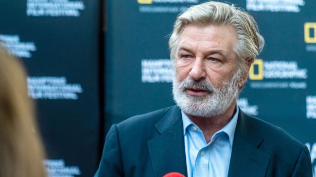 alec baldwin speaking into a microphone
