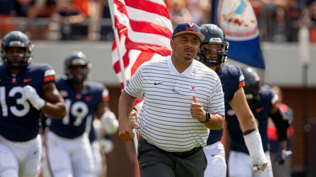 Tony Elliott runs out onto the field before a game against Virginia and Old Dominion.