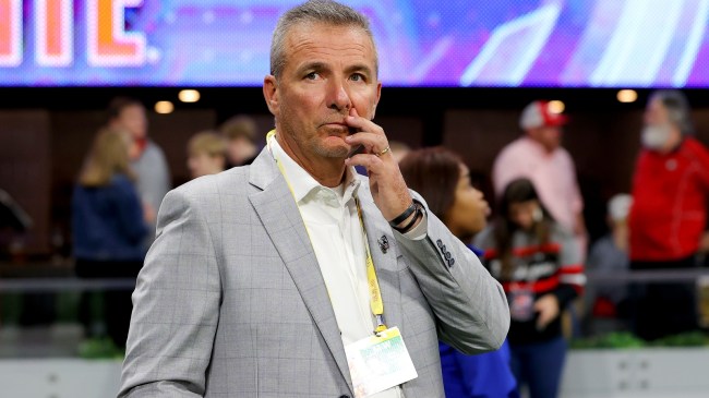 Urban Meyer stands on the sidelines at a football game.