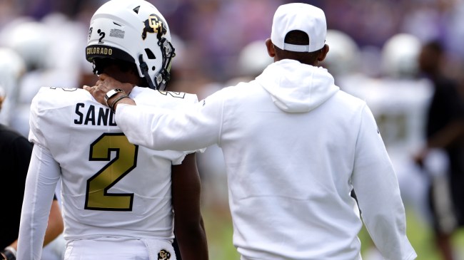 Deion Sanders walks onto the field with his son, Shedeur.