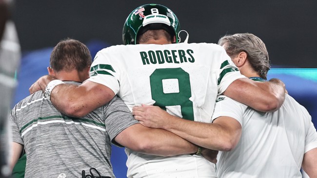 Aaron Rodgers being helped off field off tearing his Achilles