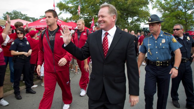 Bobby Petrino walks to the stadium before a game at Arkansas.