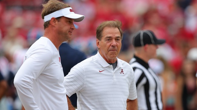 Lane Kiffin and Nick Saban talk before a game.