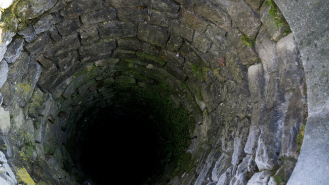 looking down a water well from above