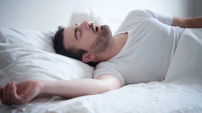 man sleeping in bed