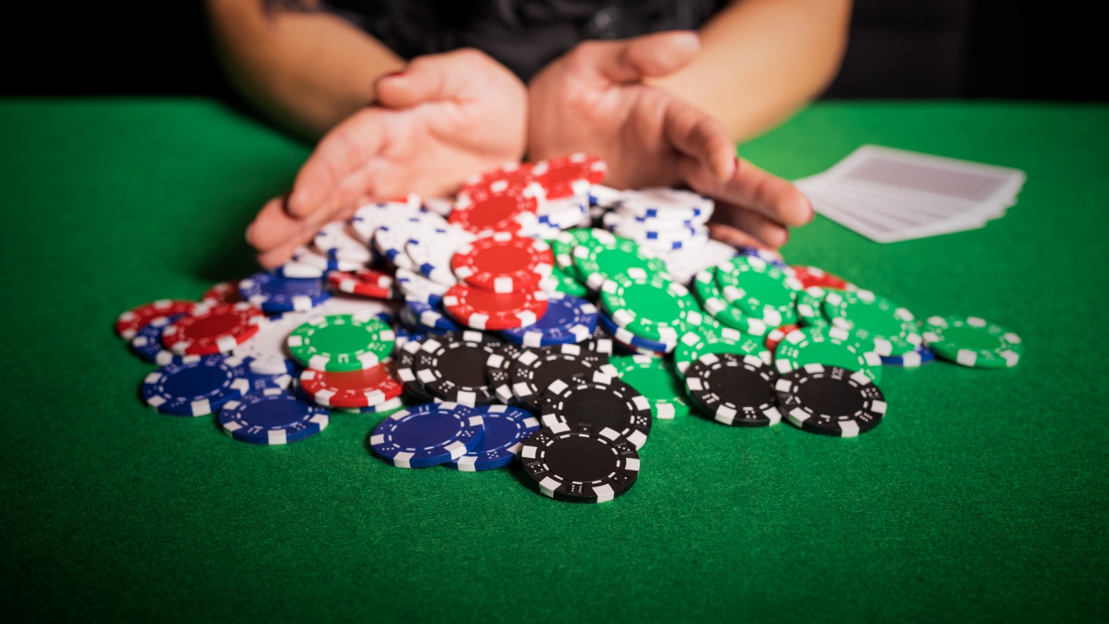 pushing poker chips into pot
