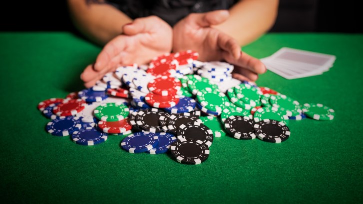 pushing poker chips into pot