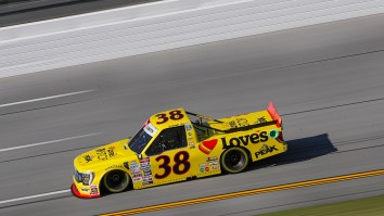 Pit Crew Member Gets Drilled By Out Of Control Vehicle, Continues Putting Tires On His Driver’s Truck