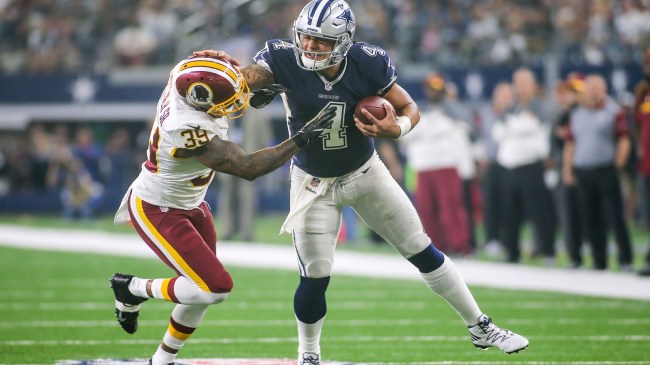 Dak Prescott stiff arms defender Donte Whitner during a game between Dallas and Washington.