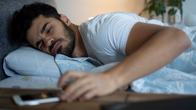 Man snoozing alarm on phone