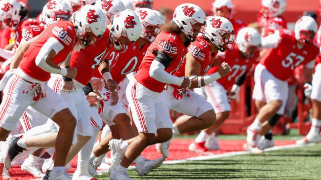 Utah players warm up on the field before a football game.