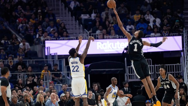 Victor Wembanyama blocks a shot by Andrew Wiggins.