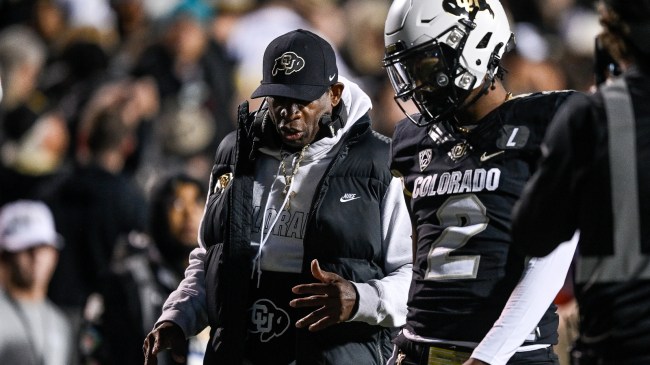 Deion Sanders talks to QB Shedeur Sanders on the sidelines.