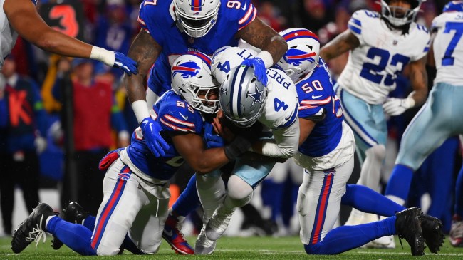 Cowboys QB Dak Prescott is sacked by a trio of Bills defenders.