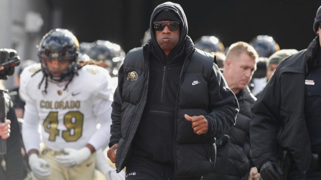 Deion Sanders runs onto the field with the Colorado football team.