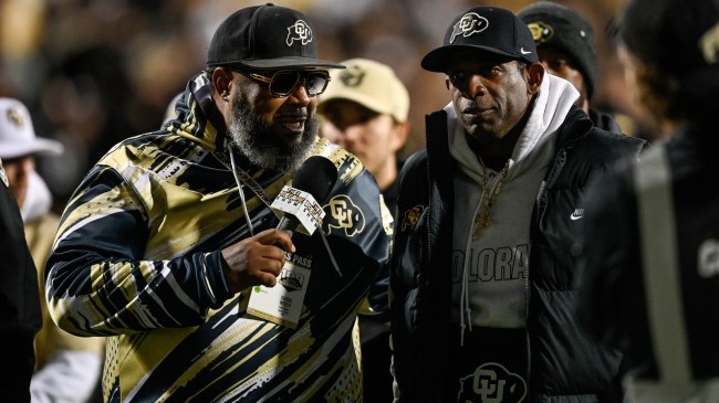 Deion Sanders talks to a Colorado sideline reporter.