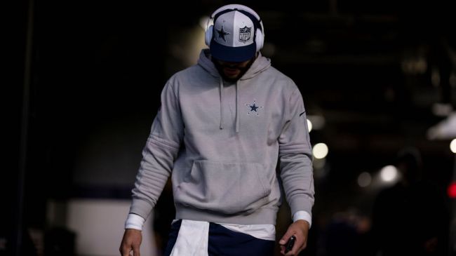 dak prescott in a cowboys hat looking down
