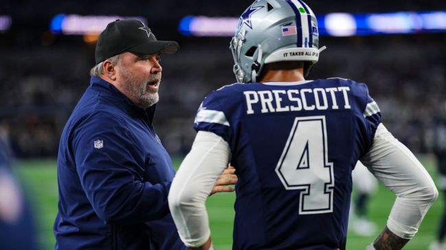 mike mccarthy and dak prescott speaking on the sideline