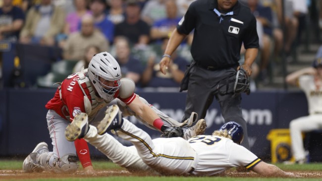 A Cincinnati Reds catcher tags a Milwaukee Brewers baserunner.