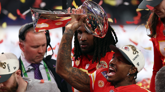 Mecole Hardman Jr of the Kansas City Chiefs raises the Lombardi Trophy