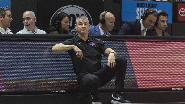 Boise State basketball coach Leon Rice leans against the scorer's table.