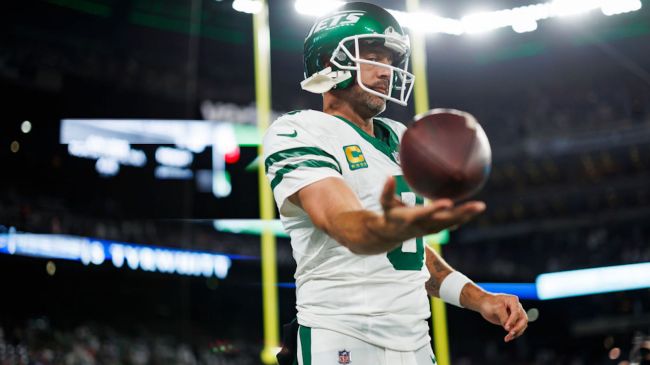 aaron rodgers holding a football