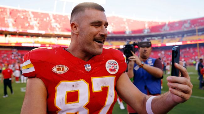 travis kelce recording a video on a cell phone