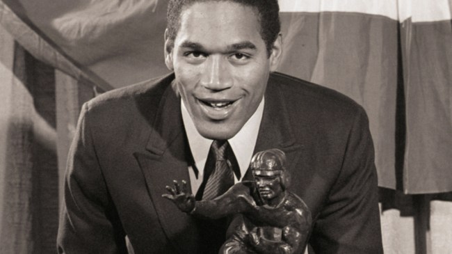 OJ Simpson holds his Heisman Trophy.