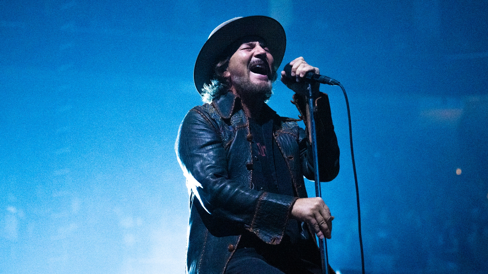Pearl Jam's Eddie Vedder sings on stage with a mic stand