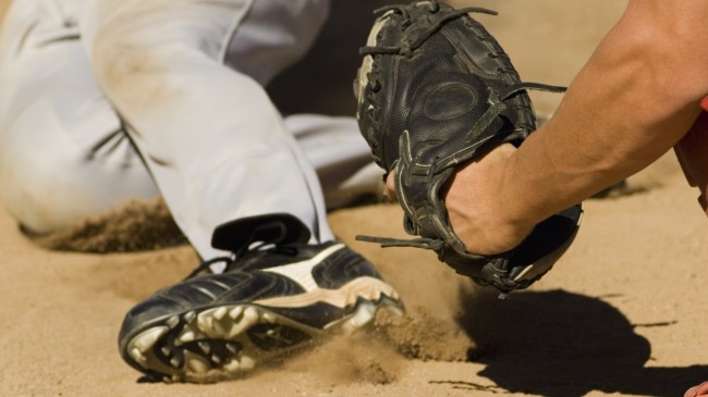 A catcher tags a baserunner during a close play at the plate.