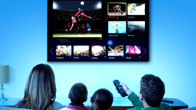 Family watching television in living room