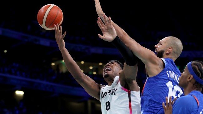 Rui Hachimura of Team Japan is defended by Evan Fournier of Team France.