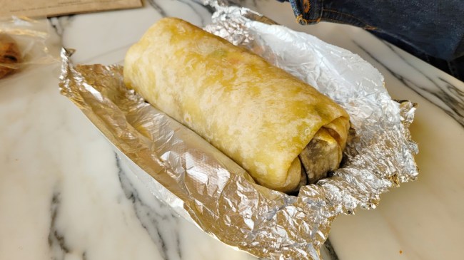 An image of a burrito wrapped in foil.