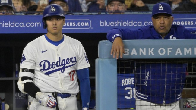 Dodgers DH Shohei Ohtani and manager Dave Roberts in the dugout.