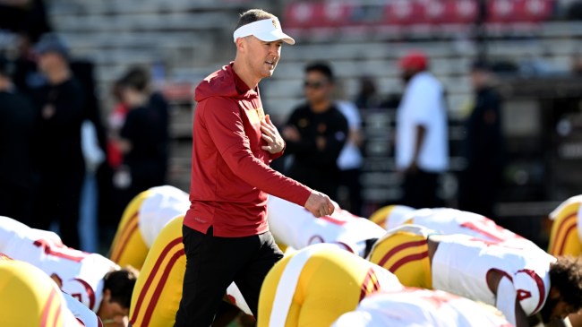 USC football coach Lincoln Riley on the field before a game.