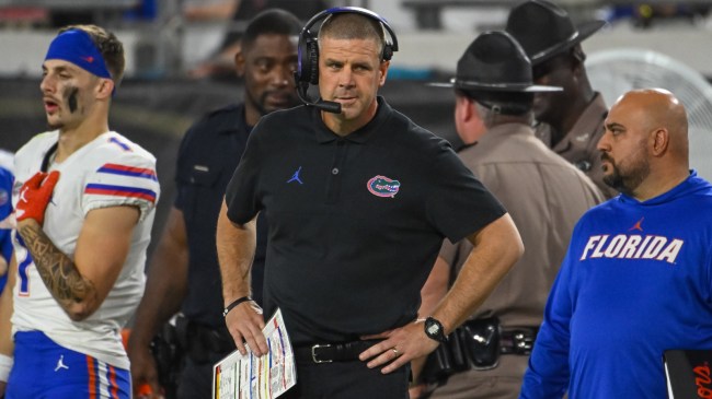 Florida football coach Billy Napier stands on the sidelines during a game.