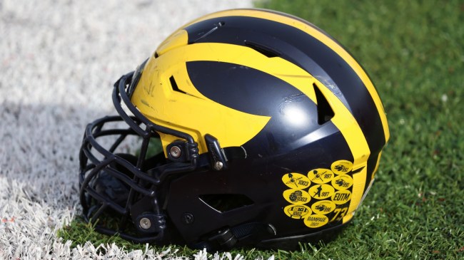 A Michigan Wolverines football helmet on the field.