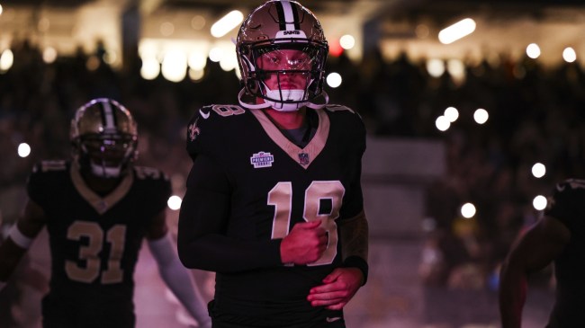 Spencer Rattler runs out of the tunnel for the New Orleans Saints.