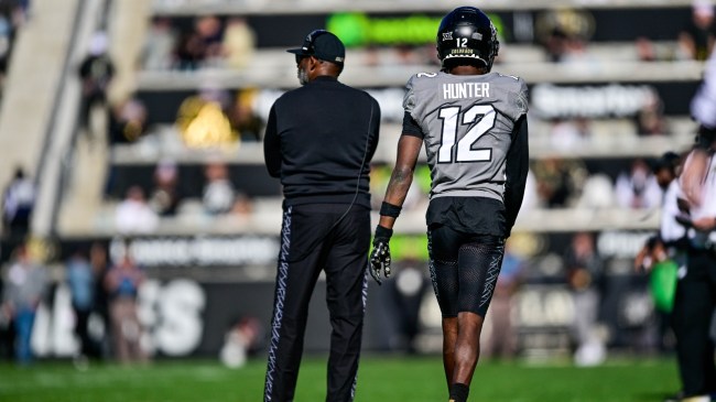 Deion Sanders and Travis Hunter on the field for the Colorado football team.