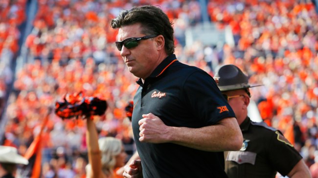 Oklahoma State football coach Mike Gundy runs onto the field.