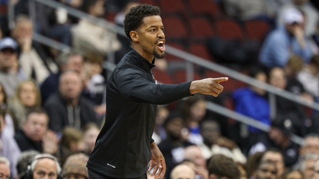 Providence basketball coach Kim English yells from the bench.