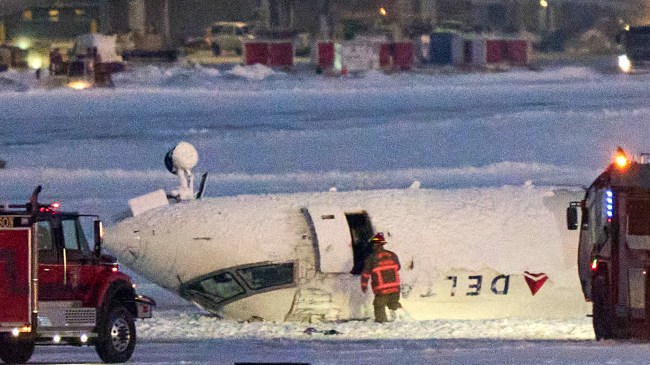 Delta airlines plane sits on its roof after crashing upon landing at Toronto Pearson Airport
