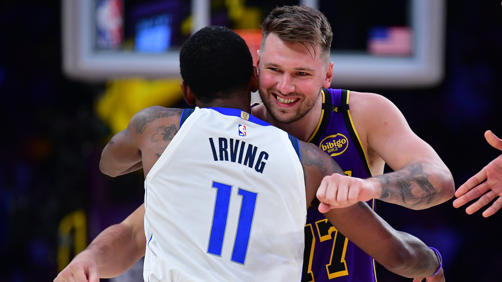 Feb 25, 2025; Los Angeles, California, USA; Los Angeles Lakers guard Luka Doncic (77) reacts with Dallas Mavericks guard Kyrie Irving (11) during the first quarter at Crypto.com Arena. Mandatory Credit: Gary A. Vasquez-Imagn Images