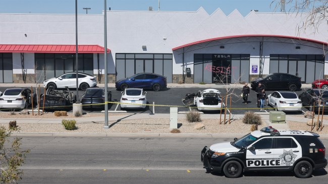 scene at a Tesla Collision Center after incendiary devices set several vehicles on fire