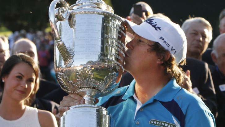 golfer Jason Dufner kissing the PGA Championship's Wanamaker Trophy at the 2013 PGA