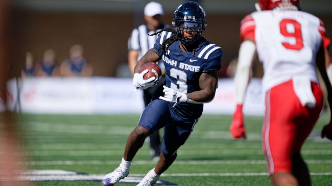 Rahsul Faison runs the ball for Utah State