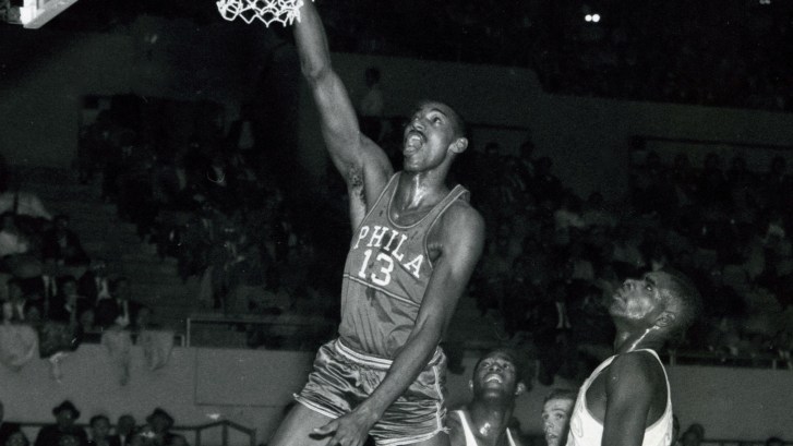Wilt Chamberlain dunking the basketball