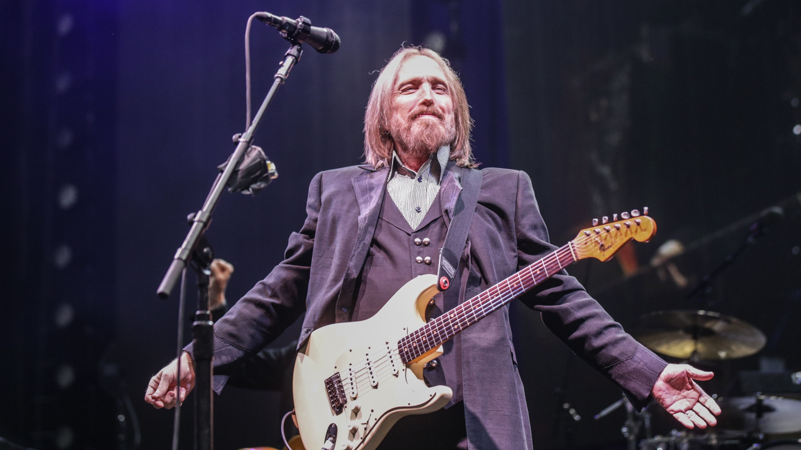 Tom Petty with his guitar on stage